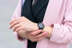 Close-up view of a modern smart ring on someone's finger showing its sleek design and sensors