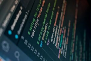 Developer working on code editor with syntax highlighting and programming interface