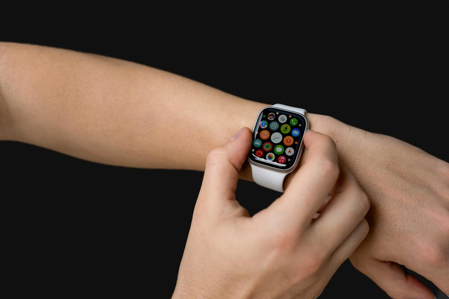 Person wearing a rugged outdoor smartwatch on their wrist during an adventure activity