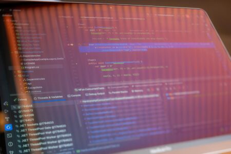 Developer working on computer with code on screen showing Docker setup process