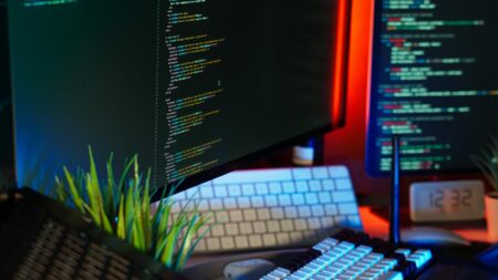Modern computer workspace setup showing collaborative software interface on screen
