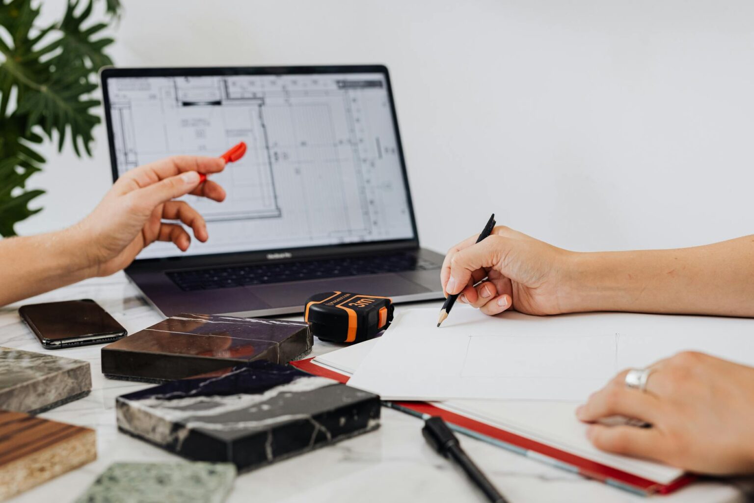 Modern workspace setup with planning materials and digital devices for project organization