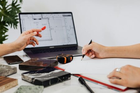 Modern workspace setup with planning materials and digital devices for project organization