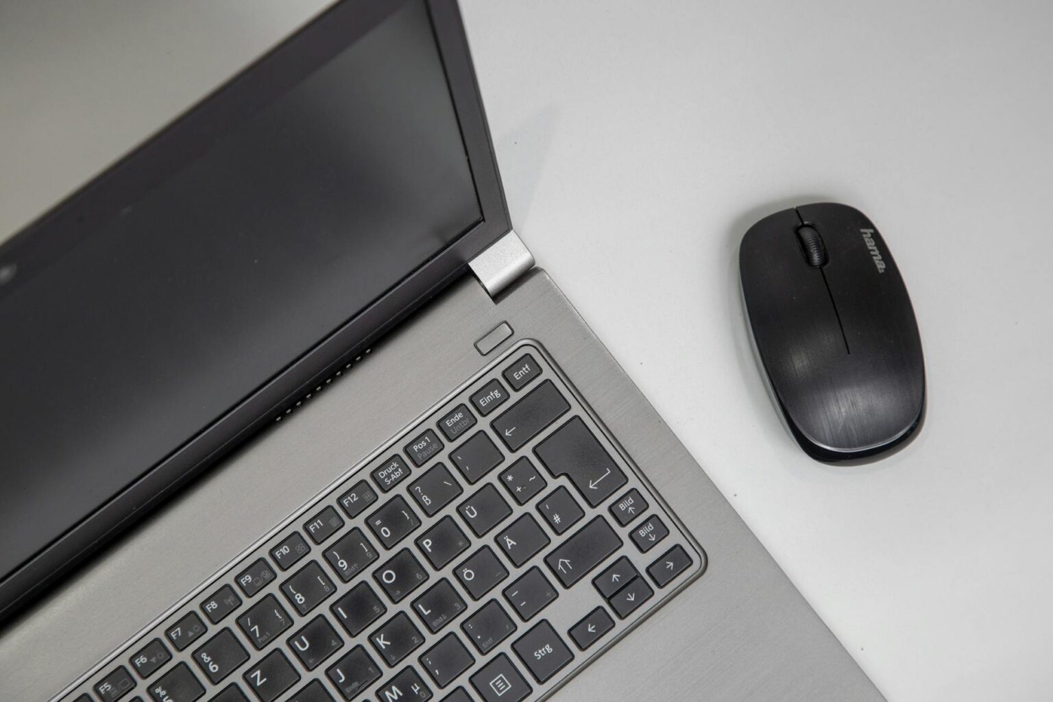 Modern ultrabook laptop on office desk with business documents and coffee cup