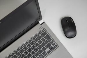 Modern ultrabook laptop on office desk with business documents and coffee cup