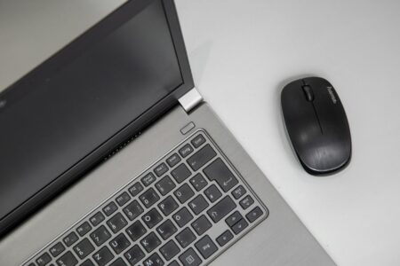 Modern ultrabook laptop on office desk with business documents and coffee cup