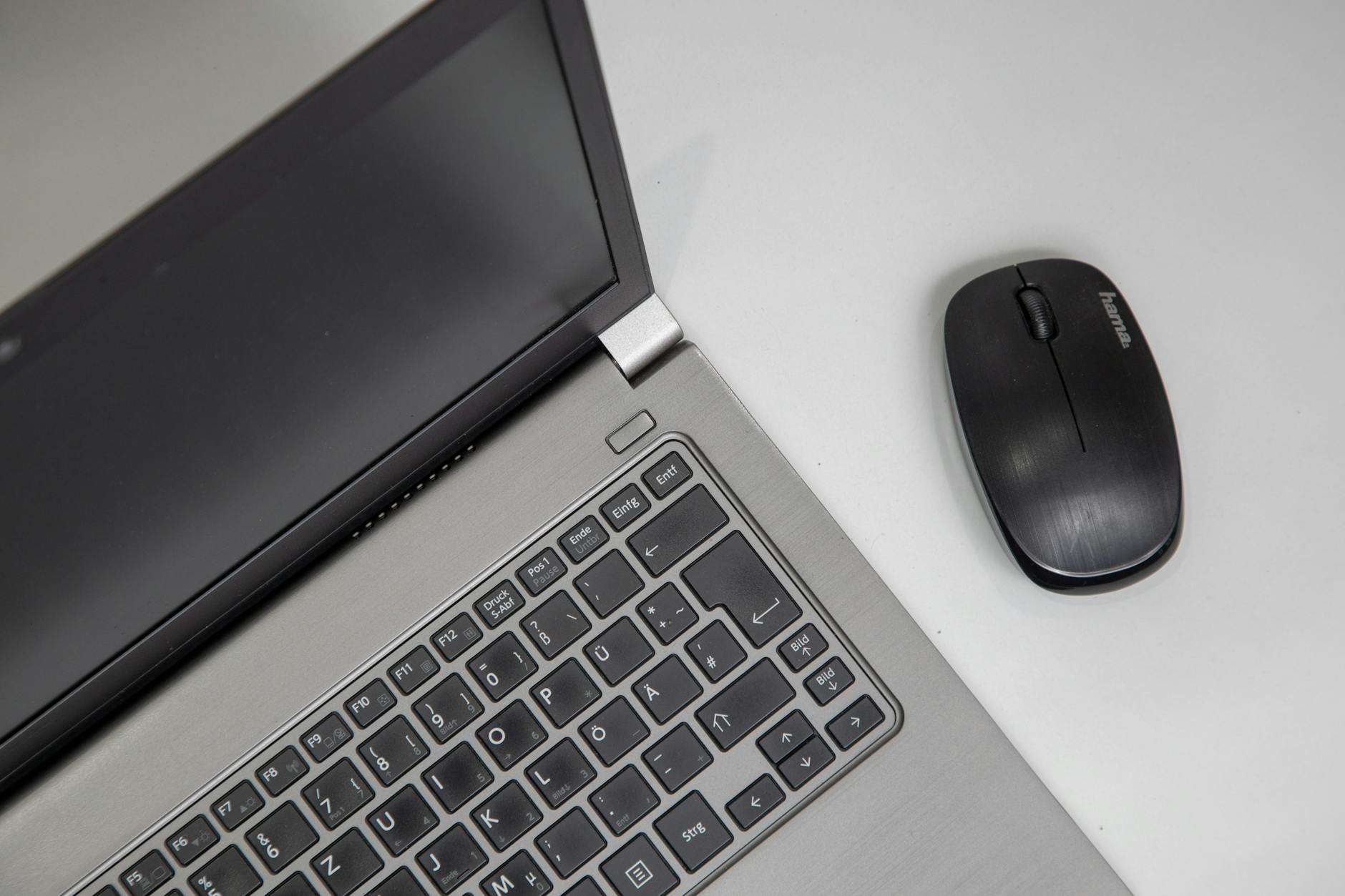 Modern ultrabook laptop on office desk with business documents and coffee cup