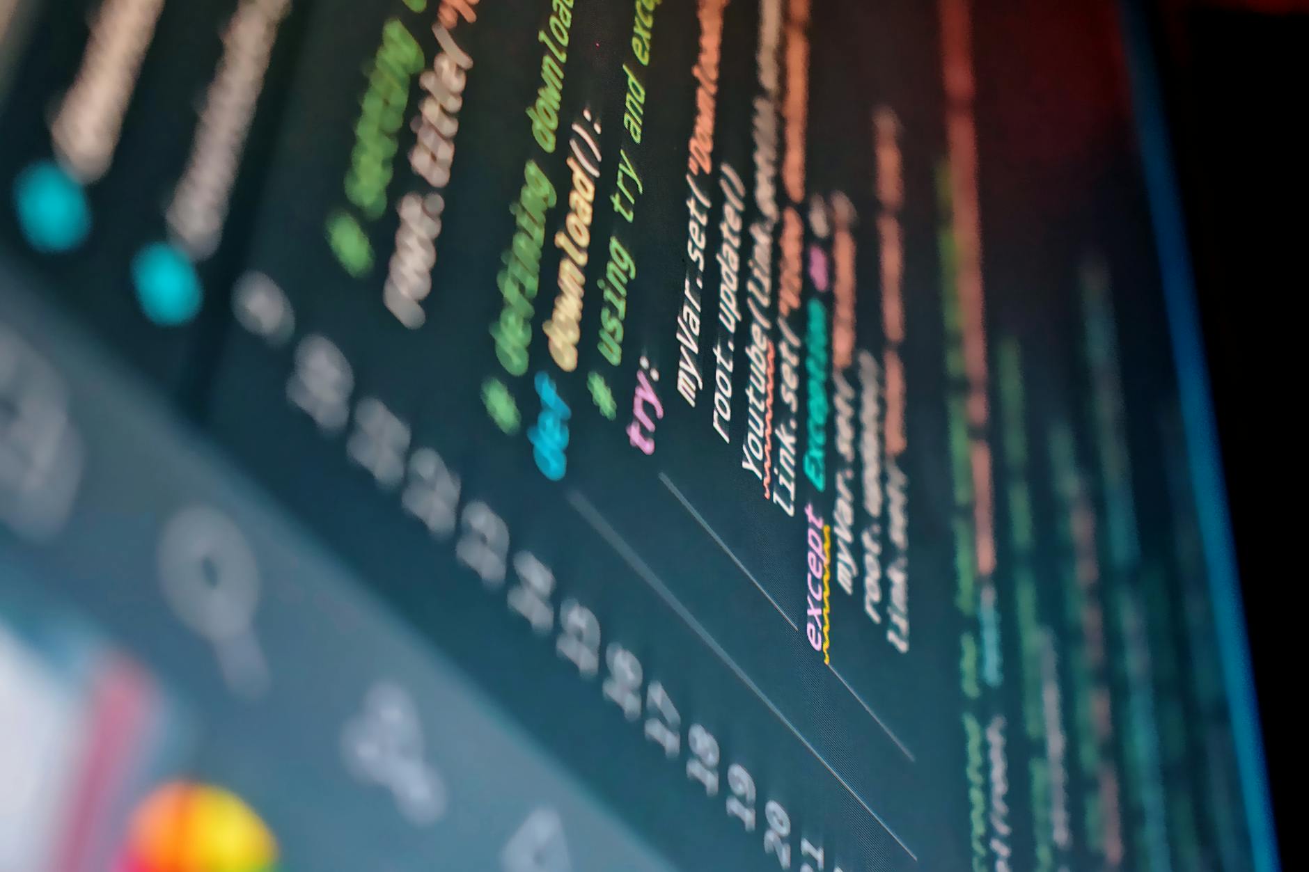 Developer working on code with multiple screens showing design and development tools