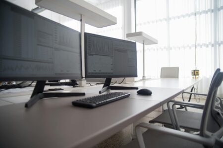 Professional computer monitor displaying colorful image on desk setup