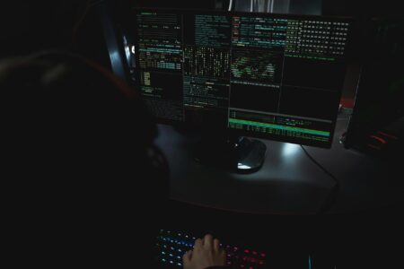 Computer monitor displaying 3D modeling software interface with complex geometric shapes