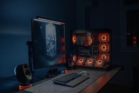Multiple computer monitors arranged on a gaming desk setup