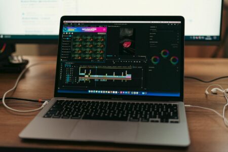 Professional video editing workstation with multiple monitors displaying color grading interface