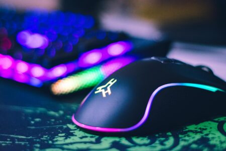 Professional gaming mouse with RGB lighting on desk setup