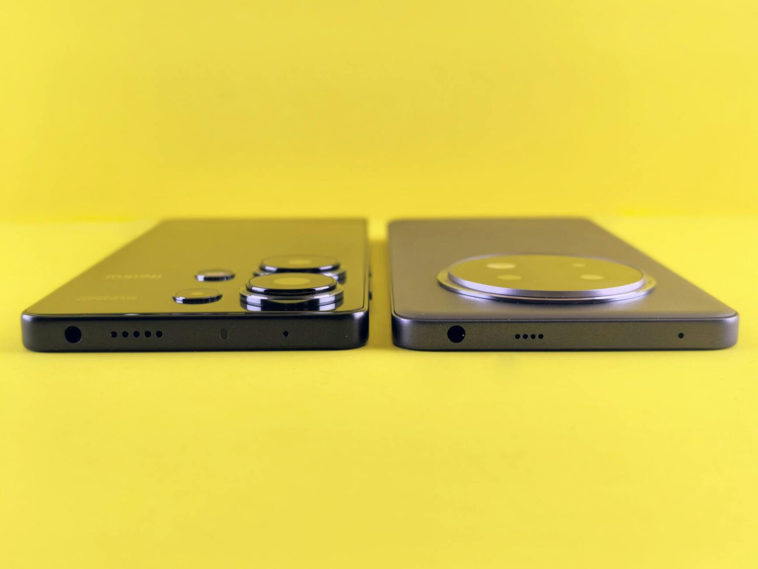 Two modern smartphones side by side showing design comparison between mid-range Android devices