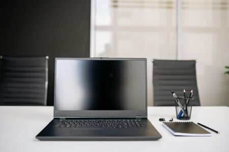 Modern laptop computer on office desk setup for remote work