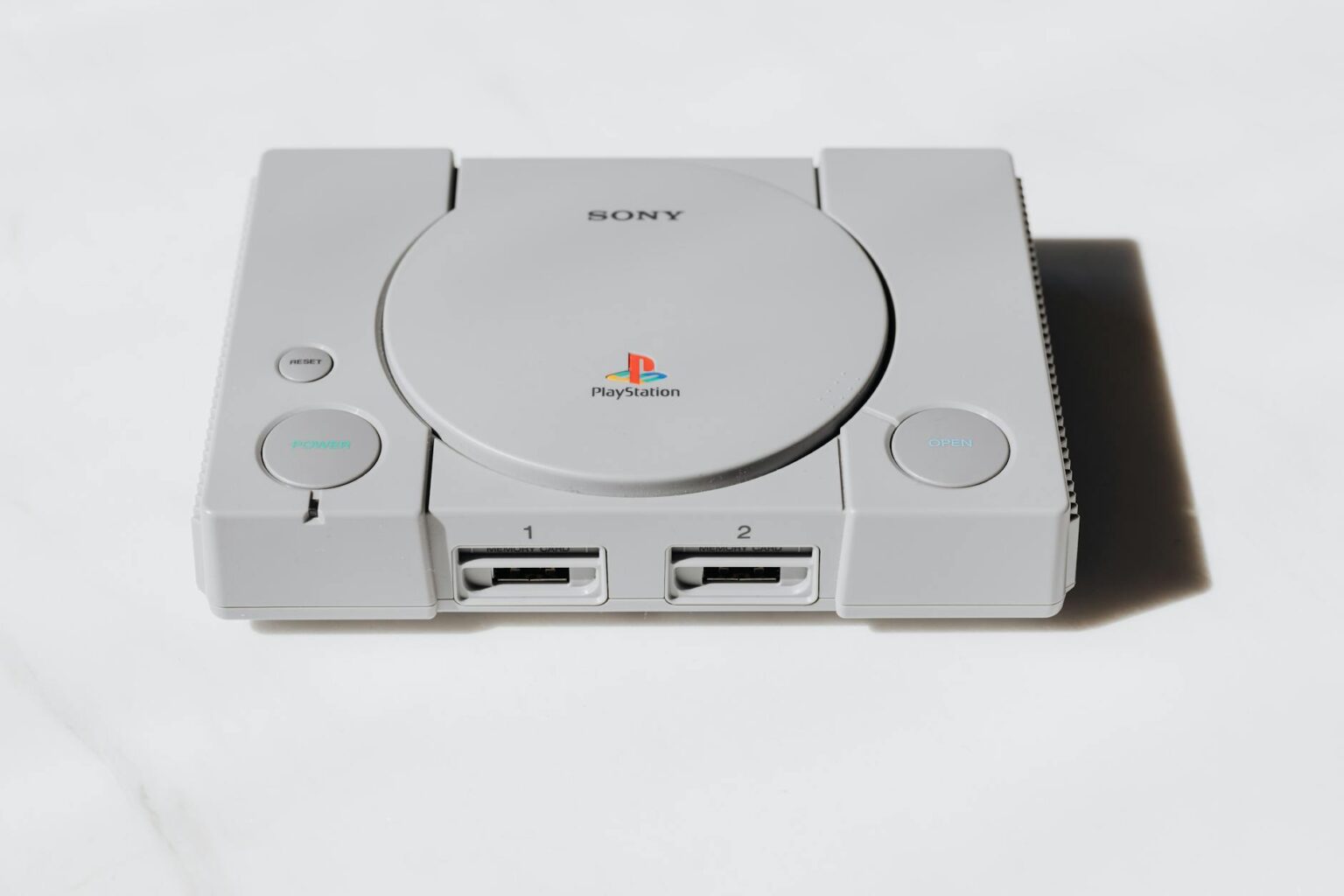 Modern handheld gaming device on desk with controllers and accessories