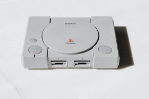 Modern handheld gaming device on desk with controllers and accessories