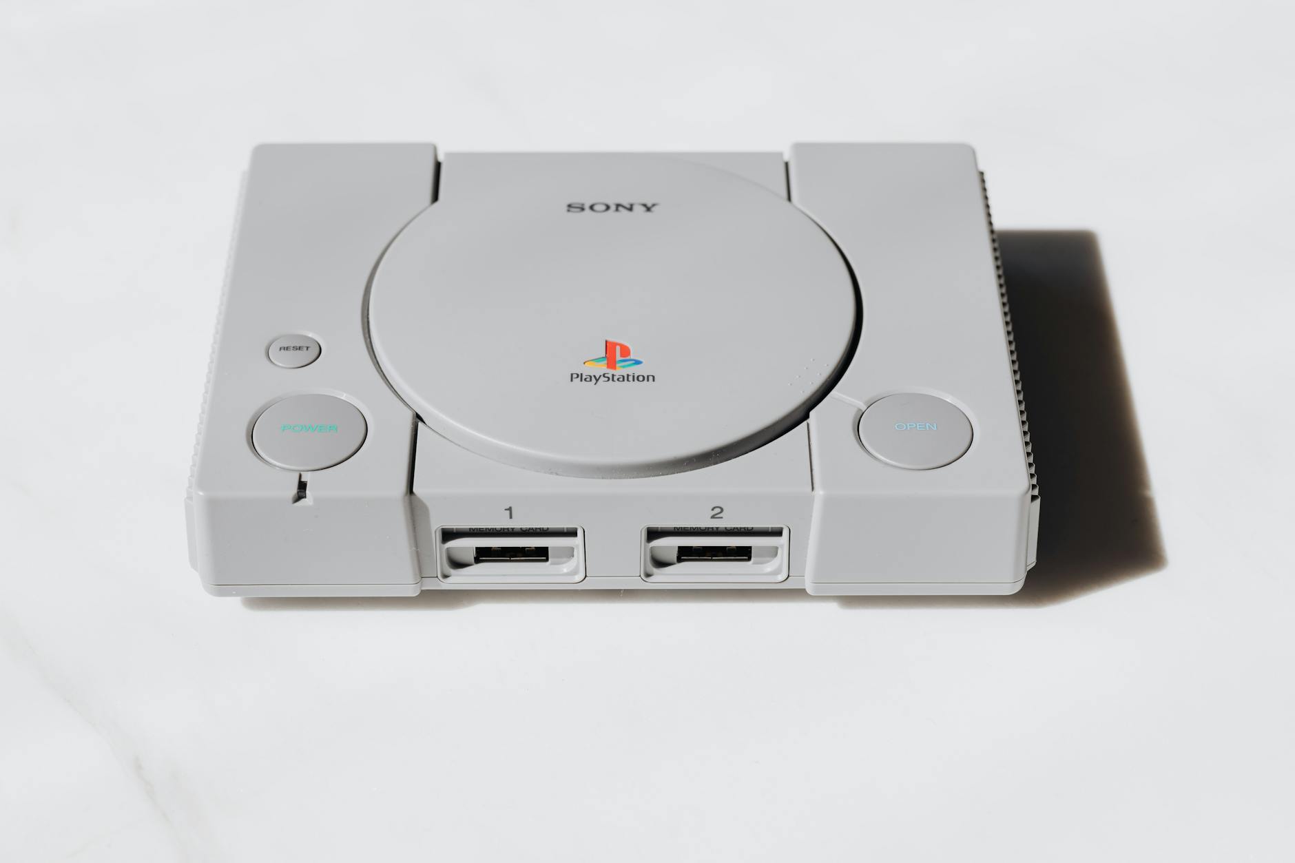 Modern handheld gaming device on desk with controllers and accessories