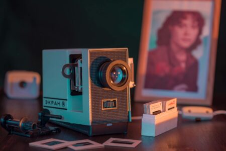 Compact mini projector displaying content on white surface in modern room