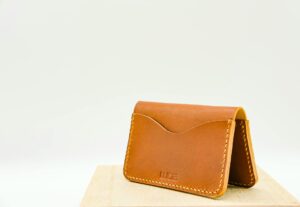 Modern leather wallet on wooden surface showing traditional design meets technology