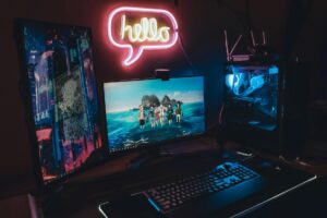 Modern gaming setup with monitor, keyboard, and controller ready for cloud gaming streaming