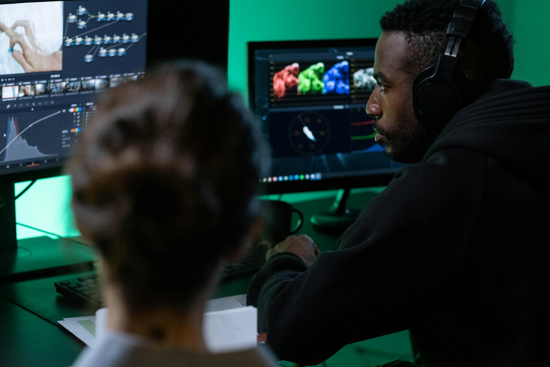Professional video editing setup with monitor displaying color grading interface