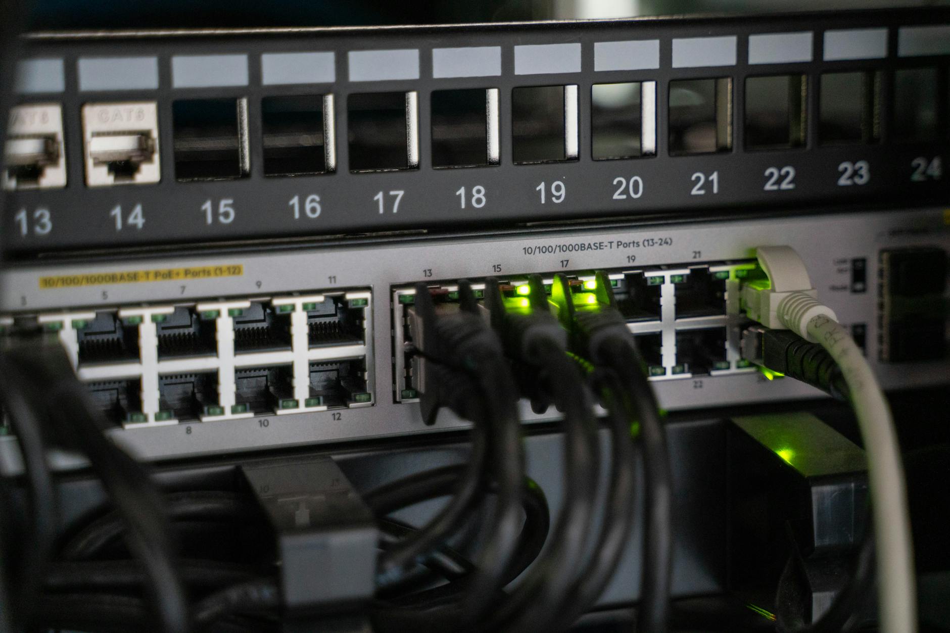 Modern wireless router with ethernet cables and LED status lights on a desk