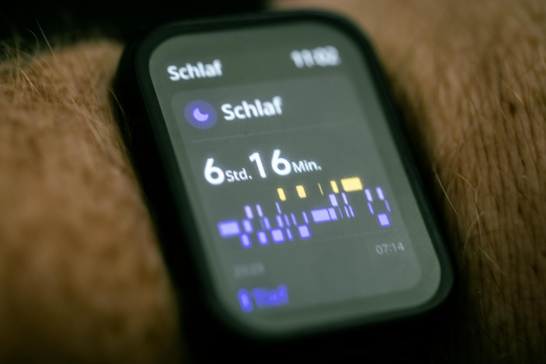 Person sleeping peacefully in bed with soft lighting, representing sleep monitoring technology