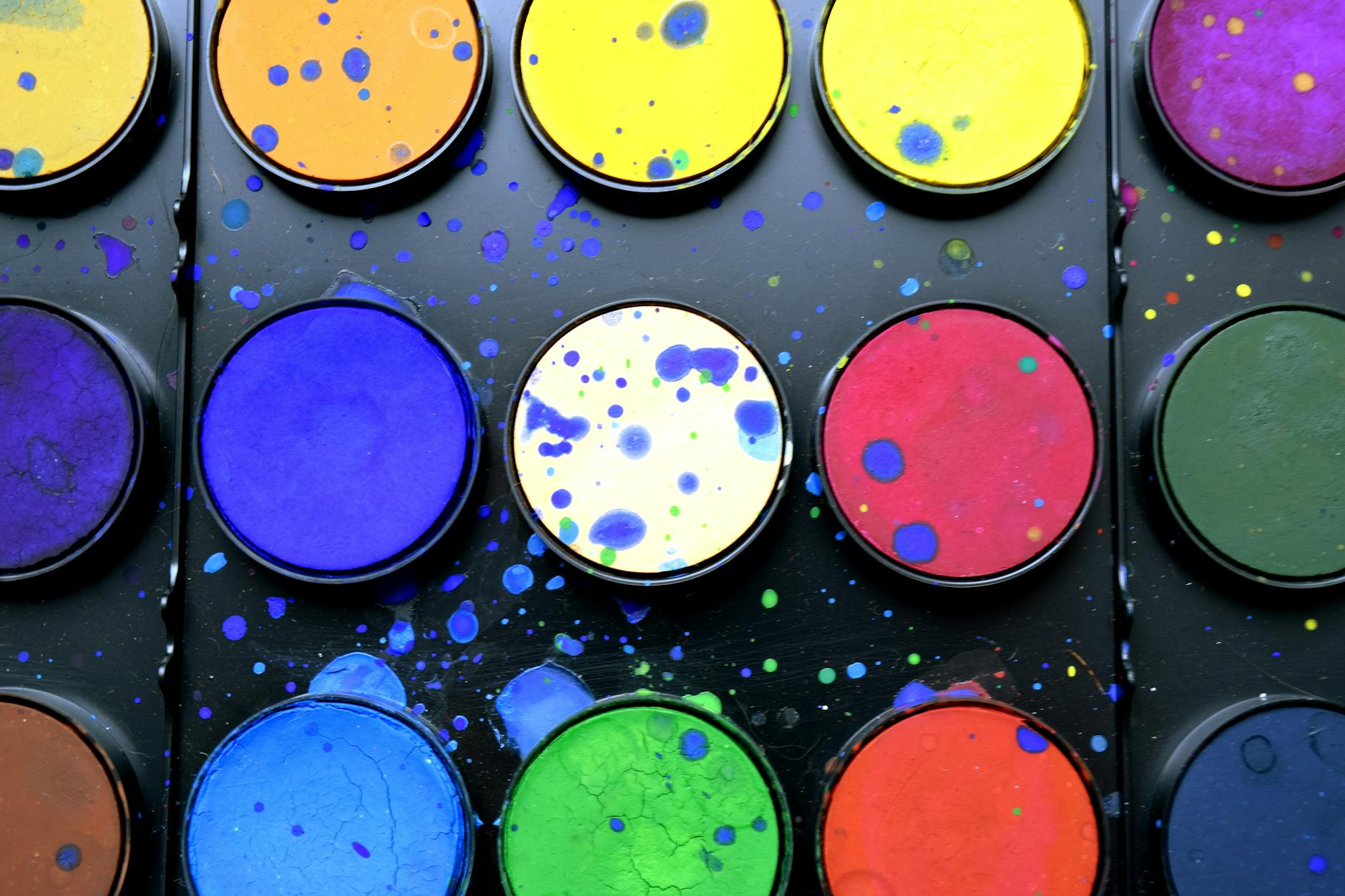 Designer's workspace showing color swatches, brand materials, and creative tools arranged on desk