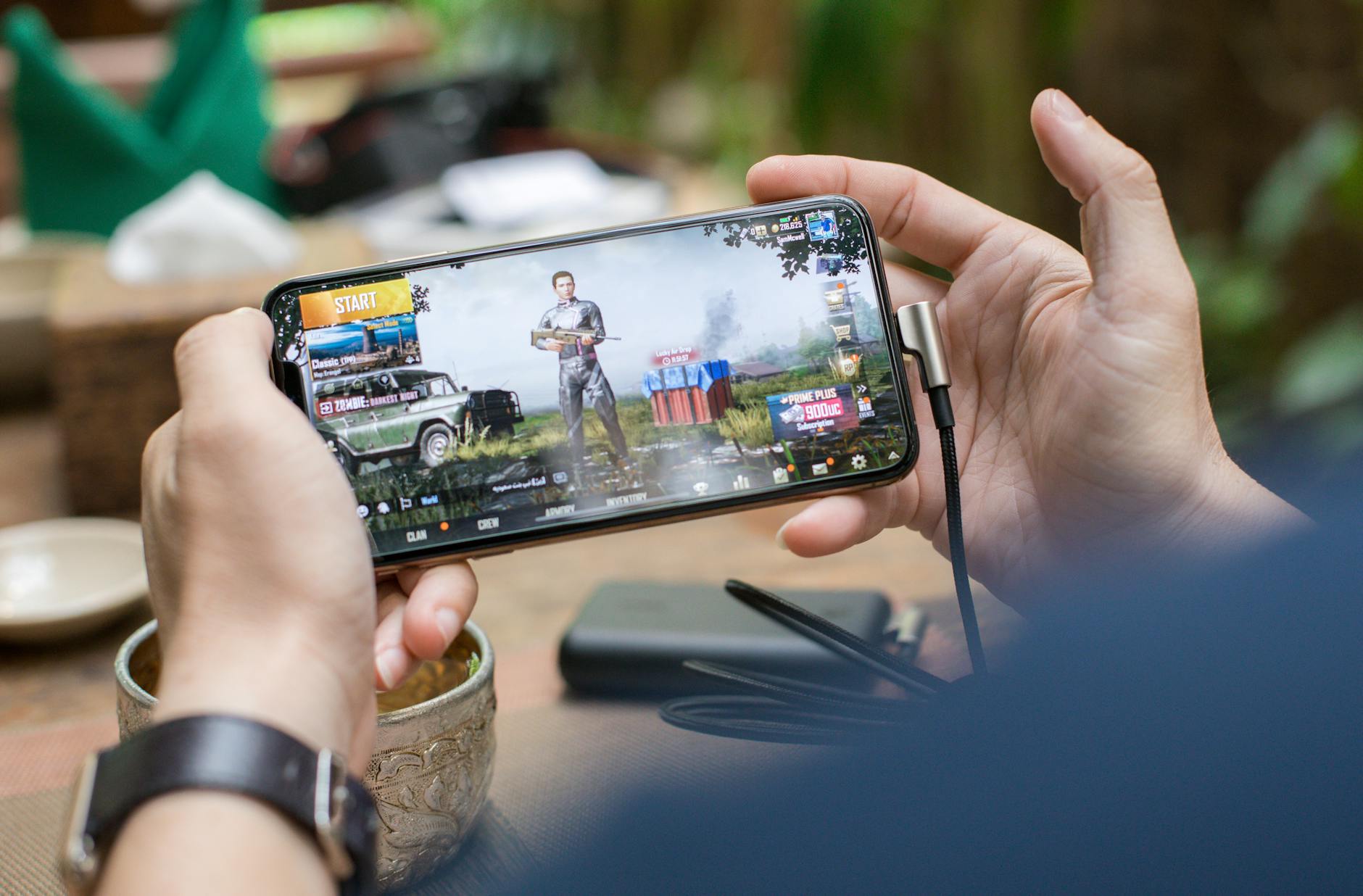 Person holding mobile gaming device showcasing portable gaming experience