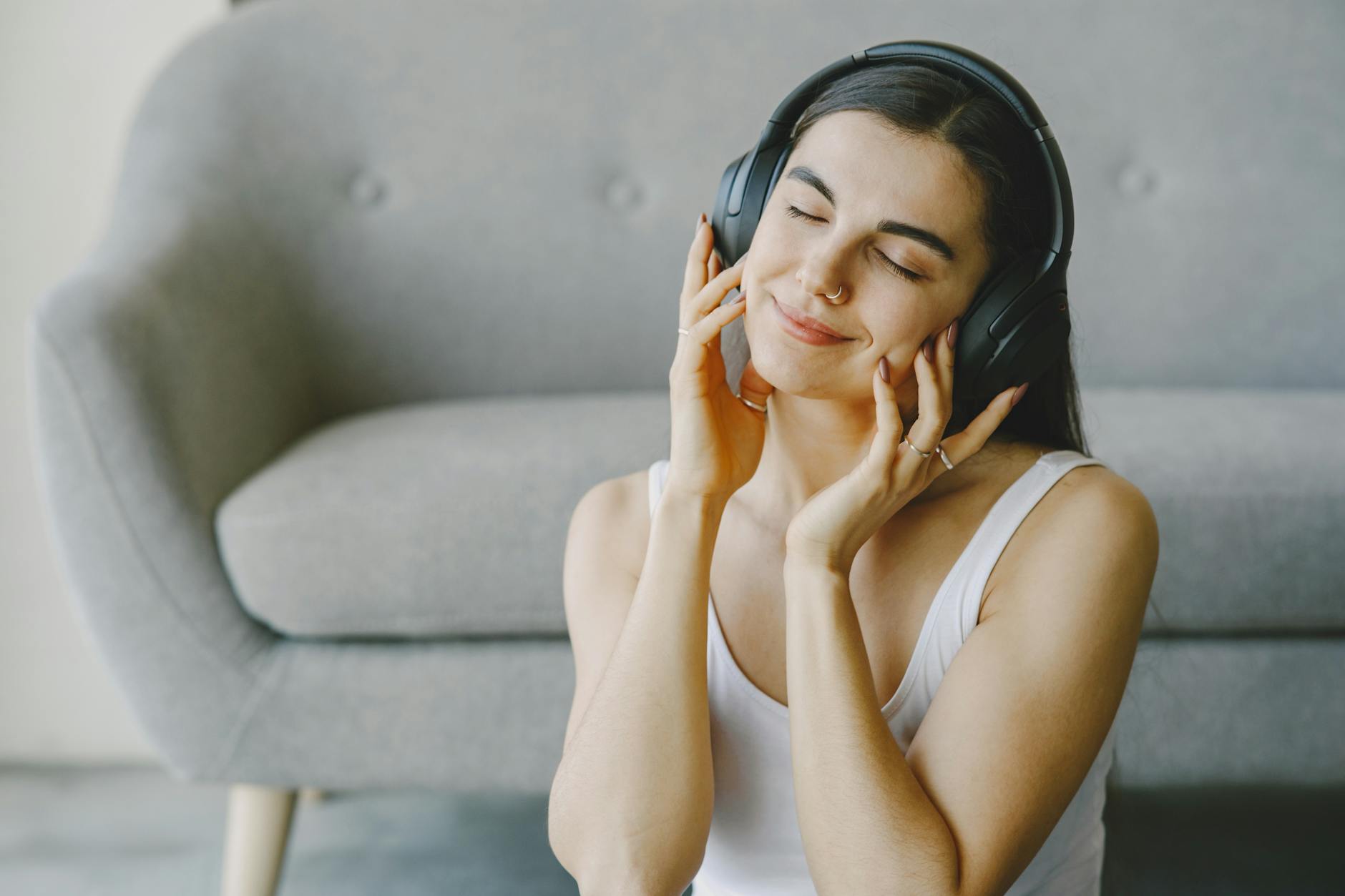 Person wearing wireless earbuds while listening to music outdoors