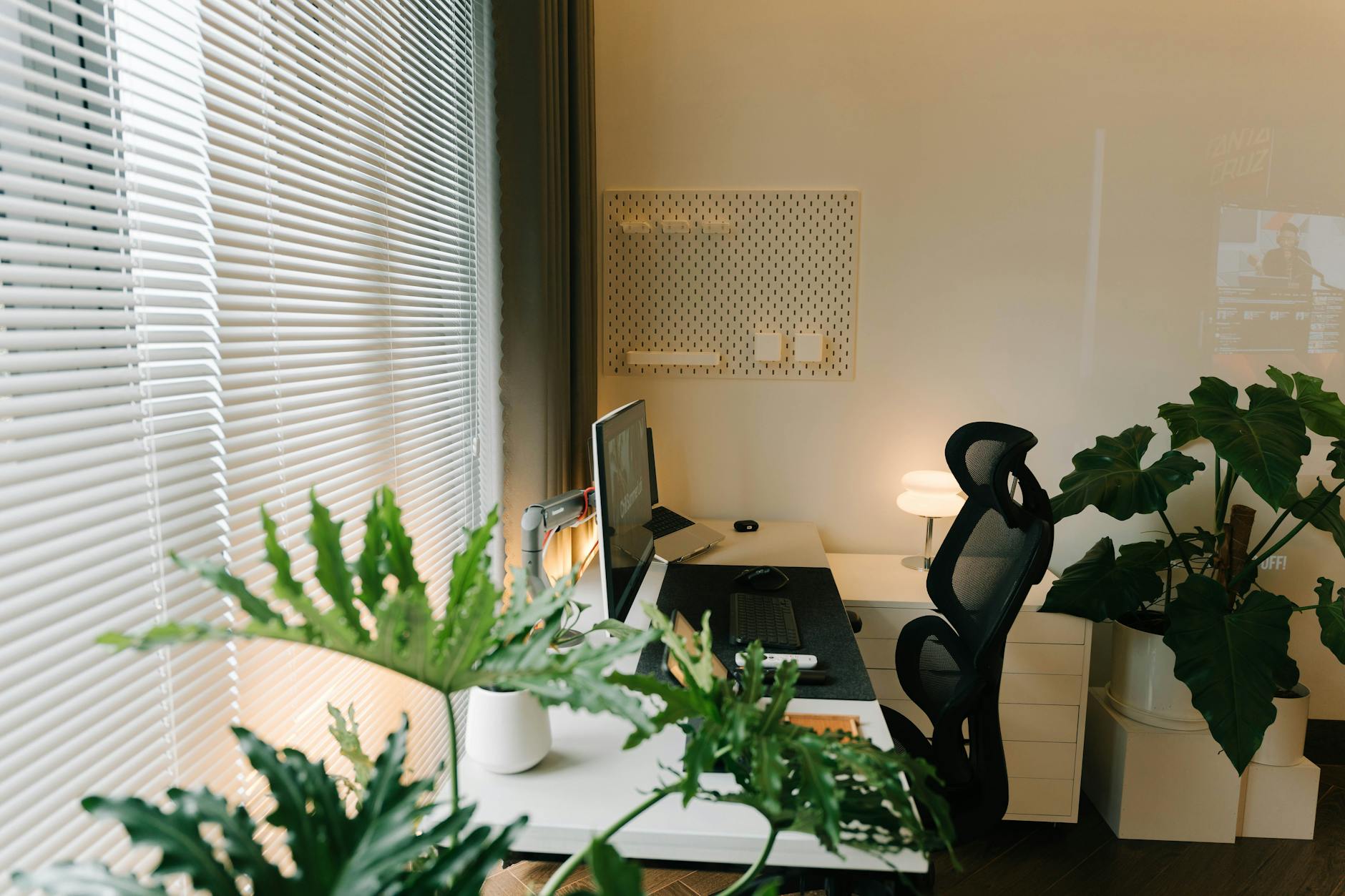 Organized office workspace with multiple monitors displaying different desktop environments