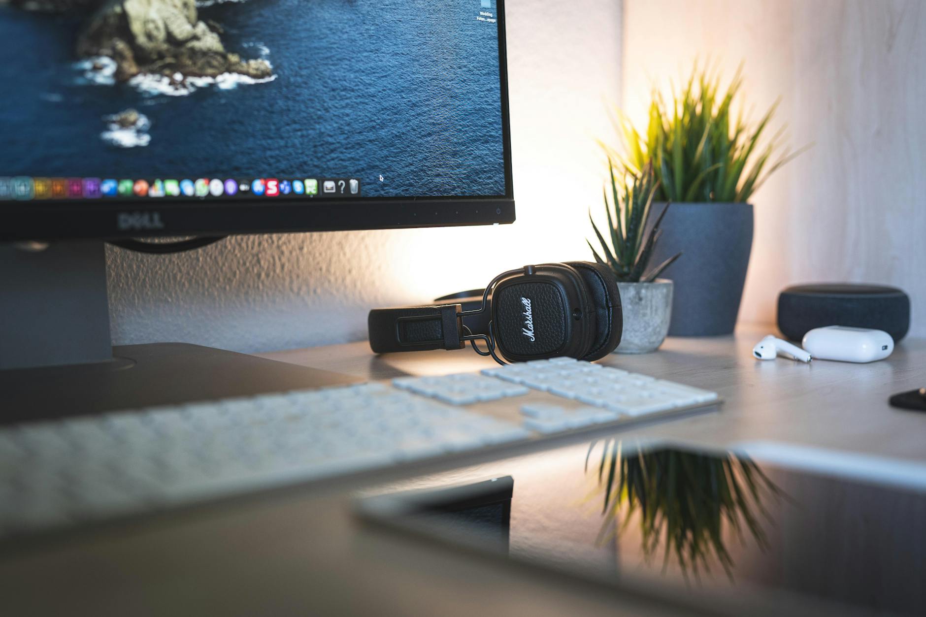 Clean desk workspace with wireless charging stand and mobile devices