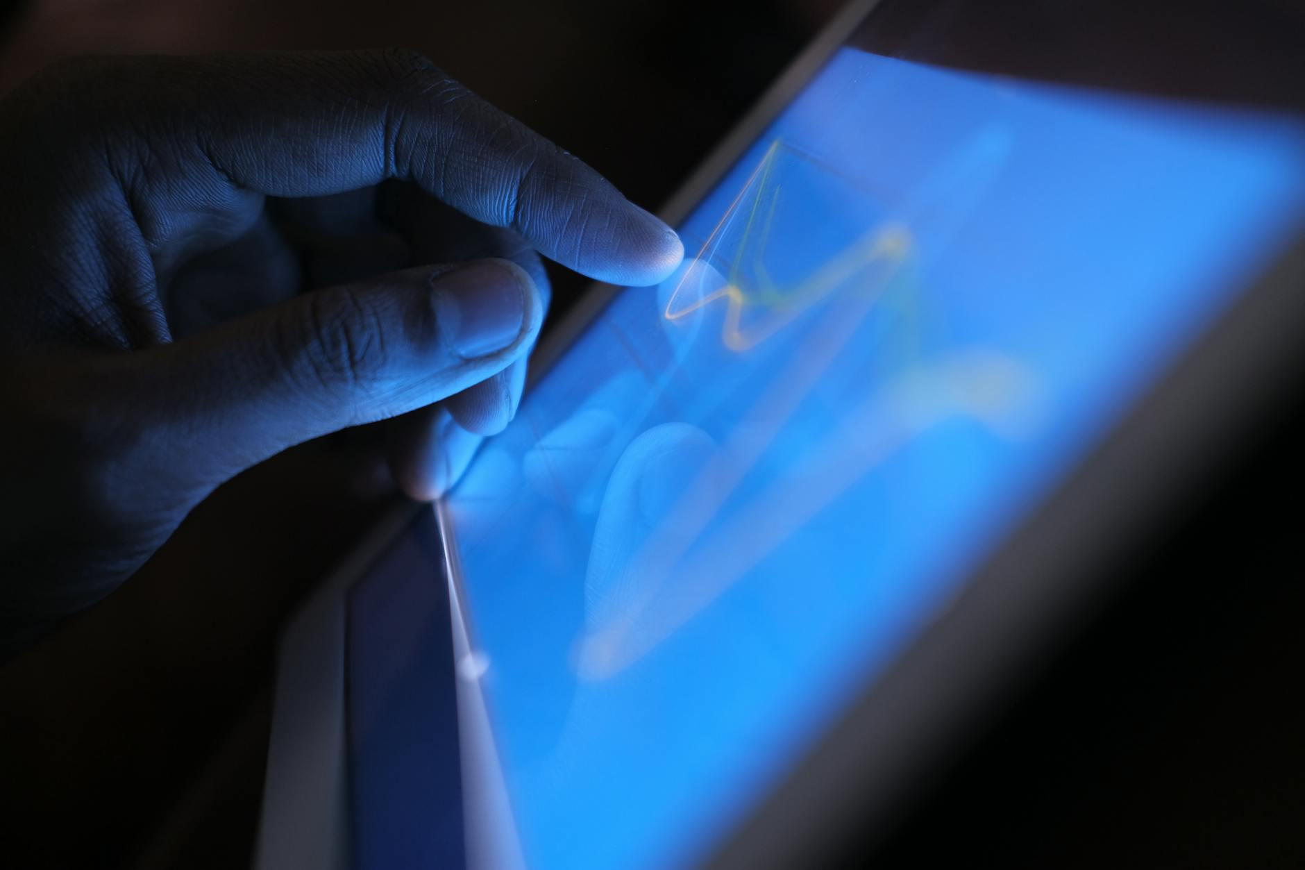 Person using touchscreen device with dual display functionality