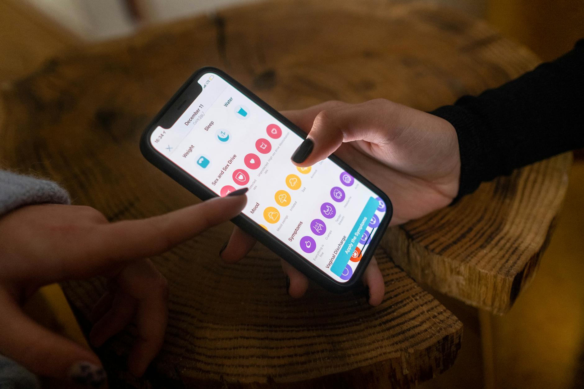 Hand holding smartphone displaying smart home security app with door lock controls
