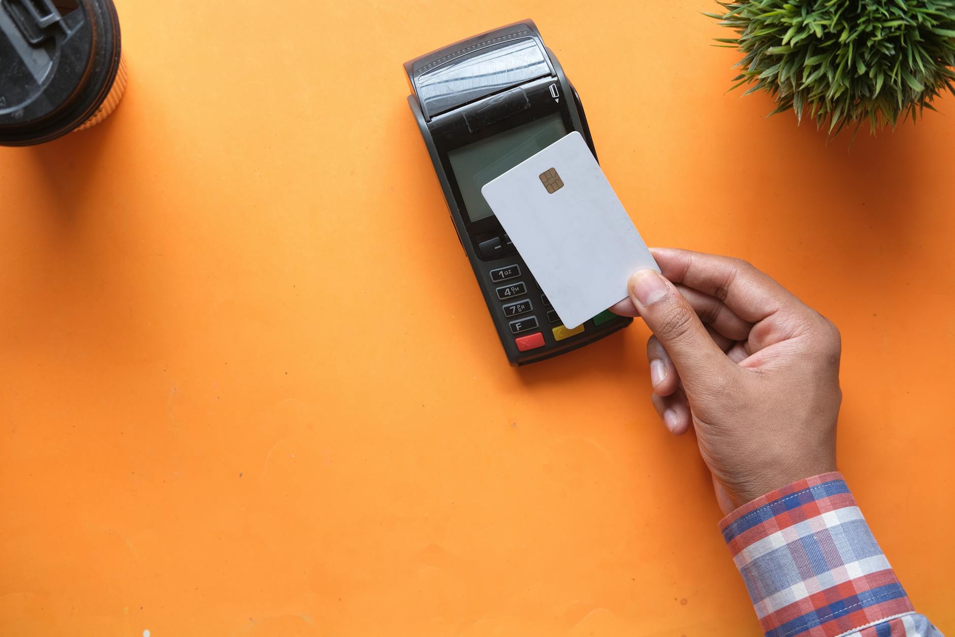 Hand making contactless payment with NFC technology at a payment terminal