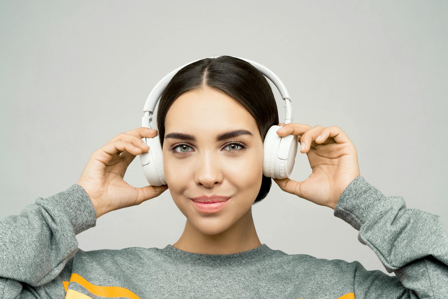 Person wearing modern headphones outdoors in urban environment
