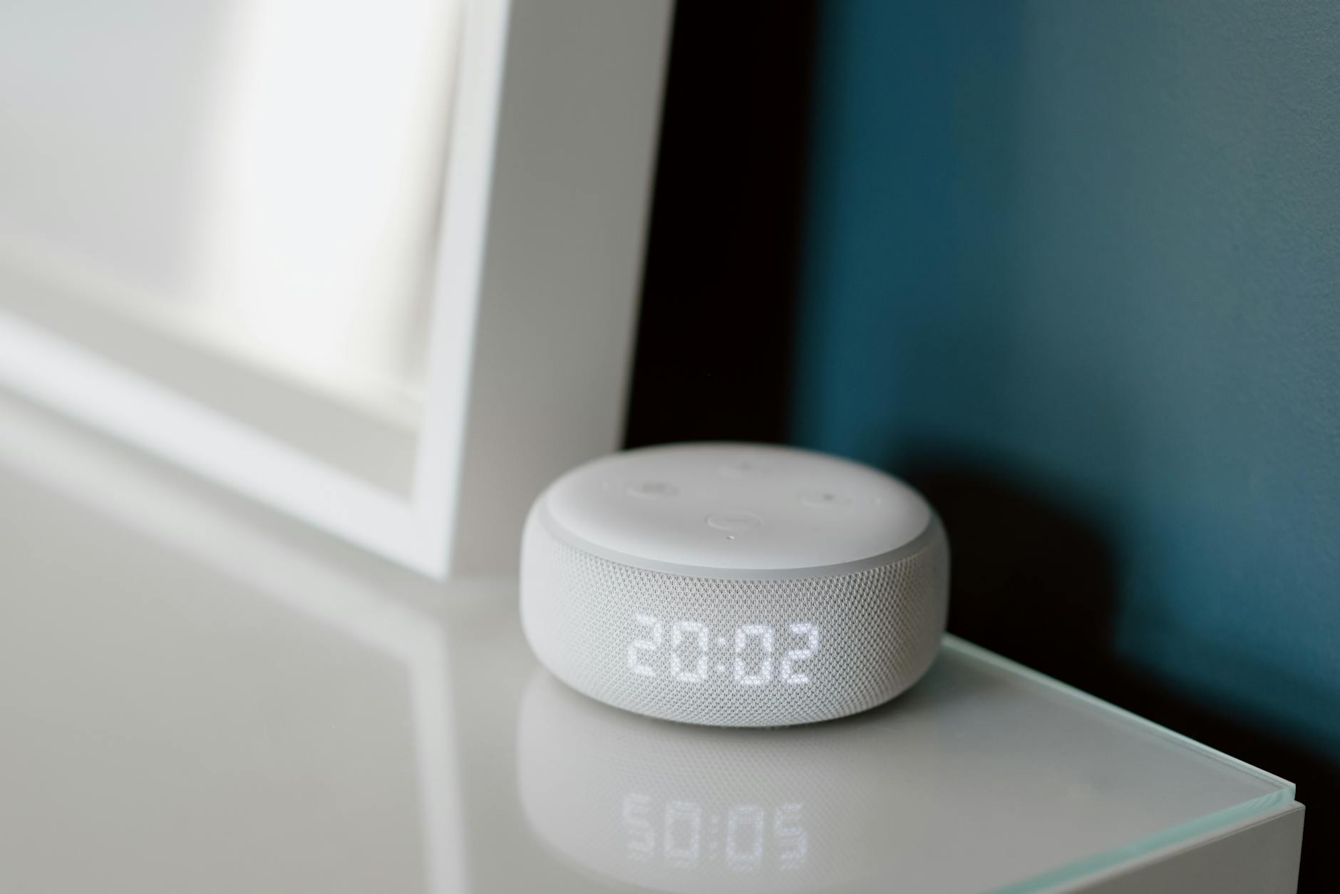 Collection of modern smart home devices including sensors and controllers on a white surface