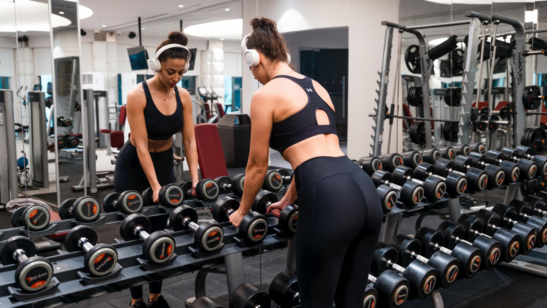 Person exercising in front of smart mirror displaying workout instructions