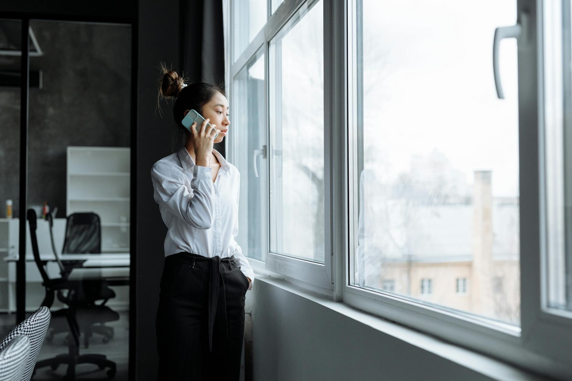 Professional person taking a business call while working at a desk with laptop