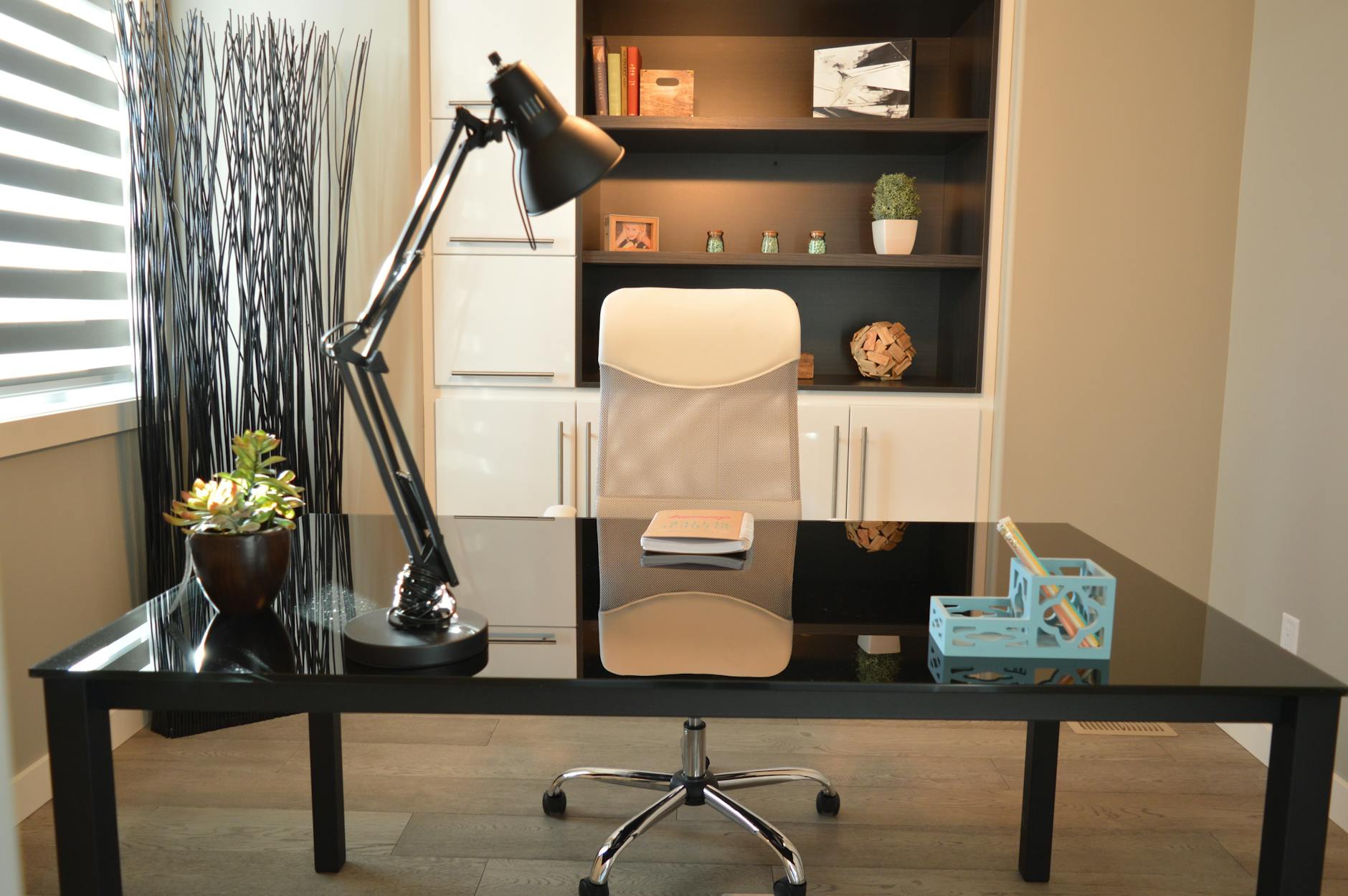 Clean organized desk setup with computer, notebook and productivity tools
