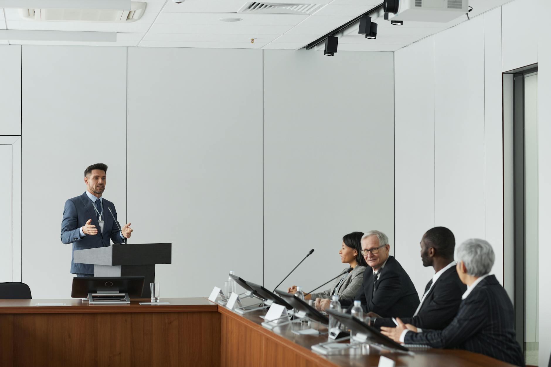 Business meeting with laptop presentation on conference room table