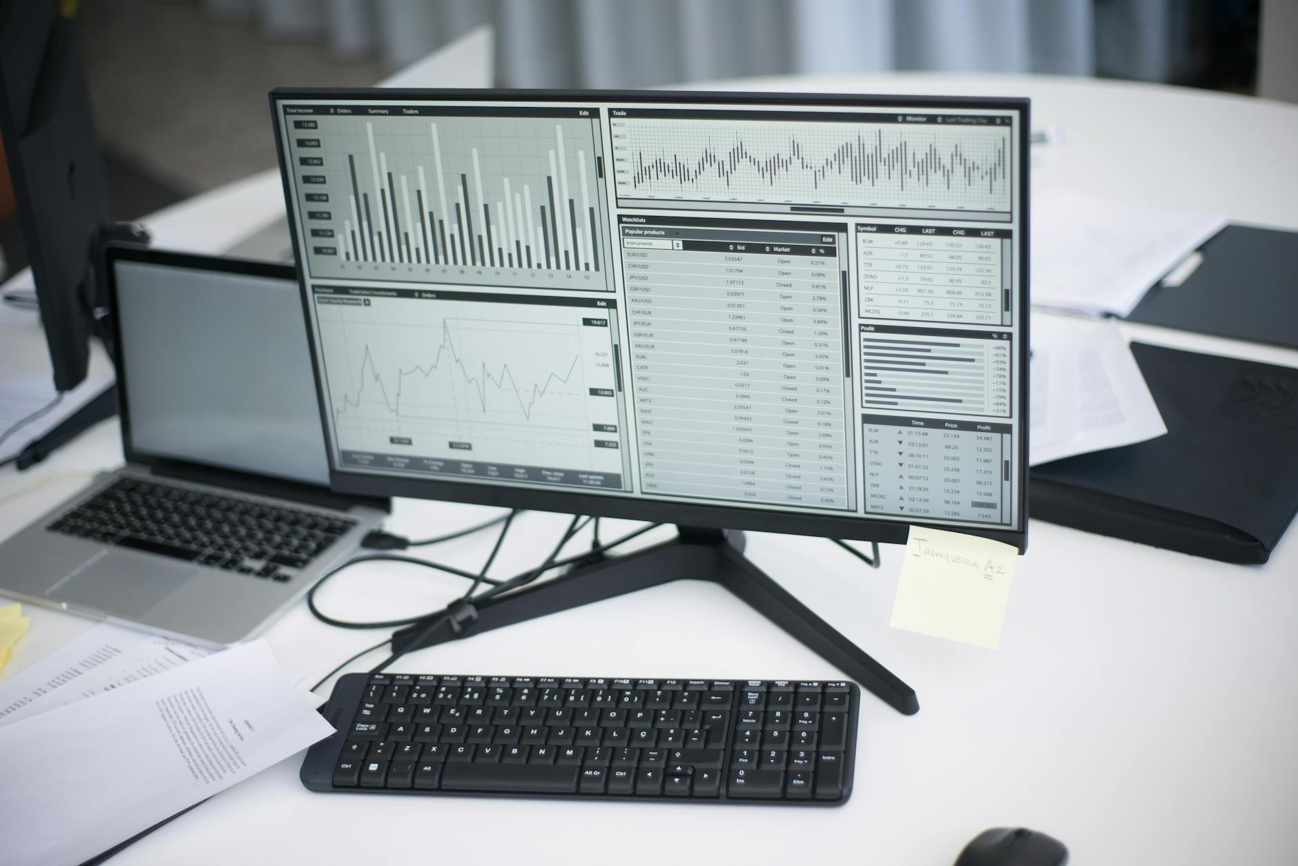 Modern workspace with laptop displaying colorful video editing timeline and effects panels