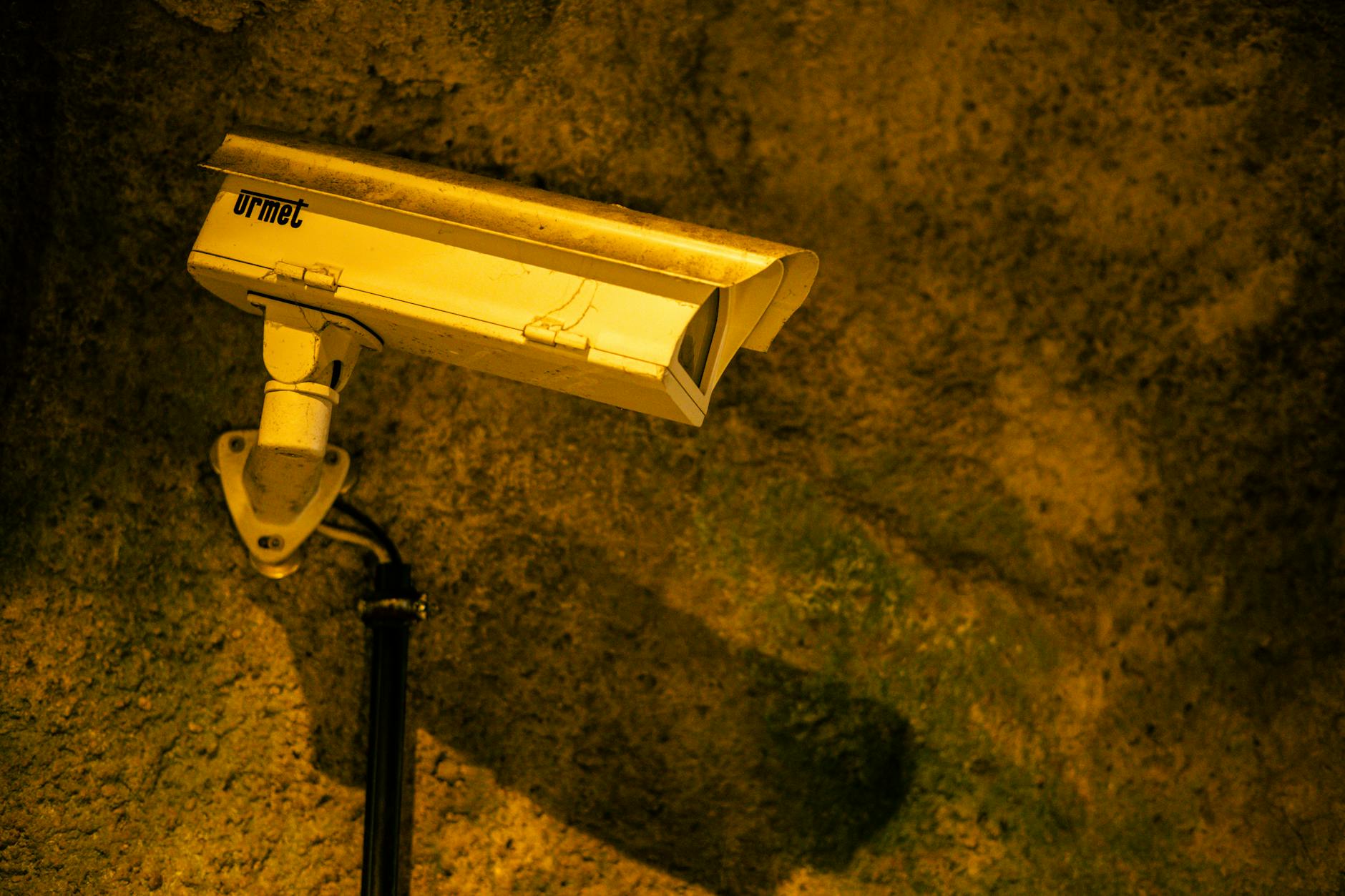 Professional surveillance monitoring setup with multiple camera feeds on computer screens