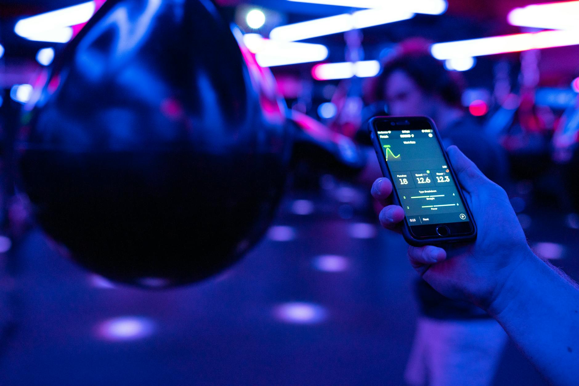 Person checking fitness metrics and data on digital display during workout session
