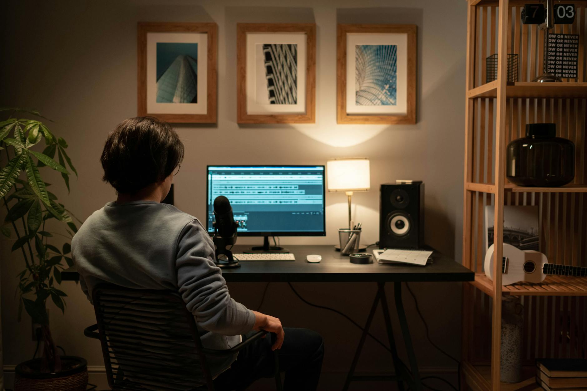 Professional animation workspace with multiple monitors showing 3D rendering and modeling projects