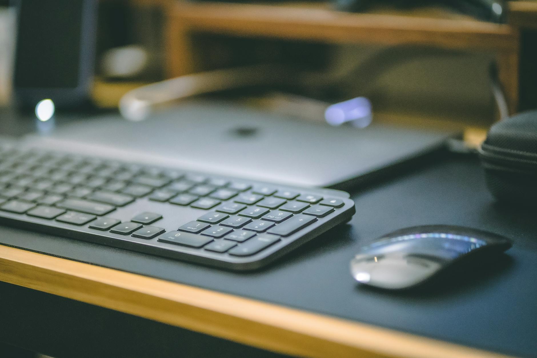 Professional office workspace with wireless mechanical keyboard and computer