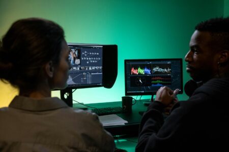 Professional video editing setup with monitor displaying color grading interface