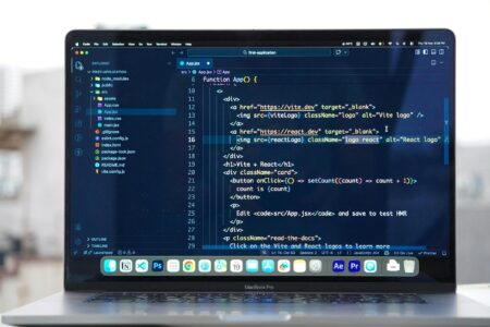Close-up of laptop screen showing code and database interface for Notion formula development