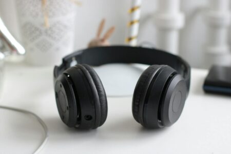 Premium over-ear wireless headphones resting on a desk surface